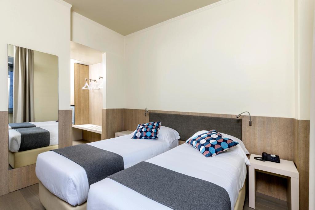 Postel nebo postele na pokoji v ubytování Living Hotel Milano