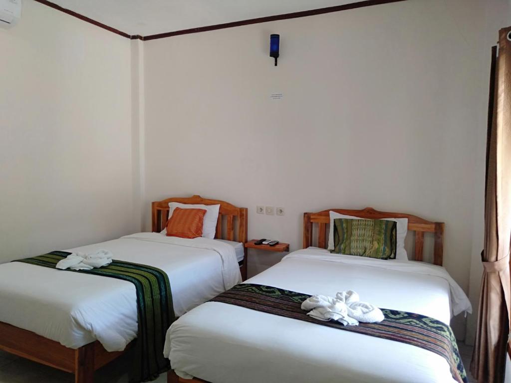 Postel nebo postele na pokoji v ubytování Jeri Home Stay