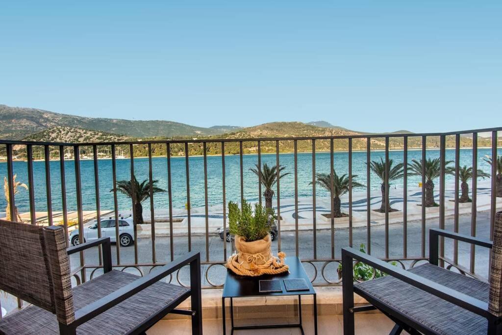 a balcony with chairs and a view of the ocean at A & B Minimal Suite with Sea View in Argostoli in Argostoli