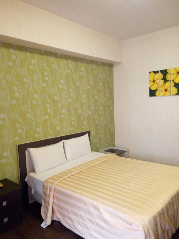 Postel nebo postele na pokoji v ubytování Kenting Aegean Sea