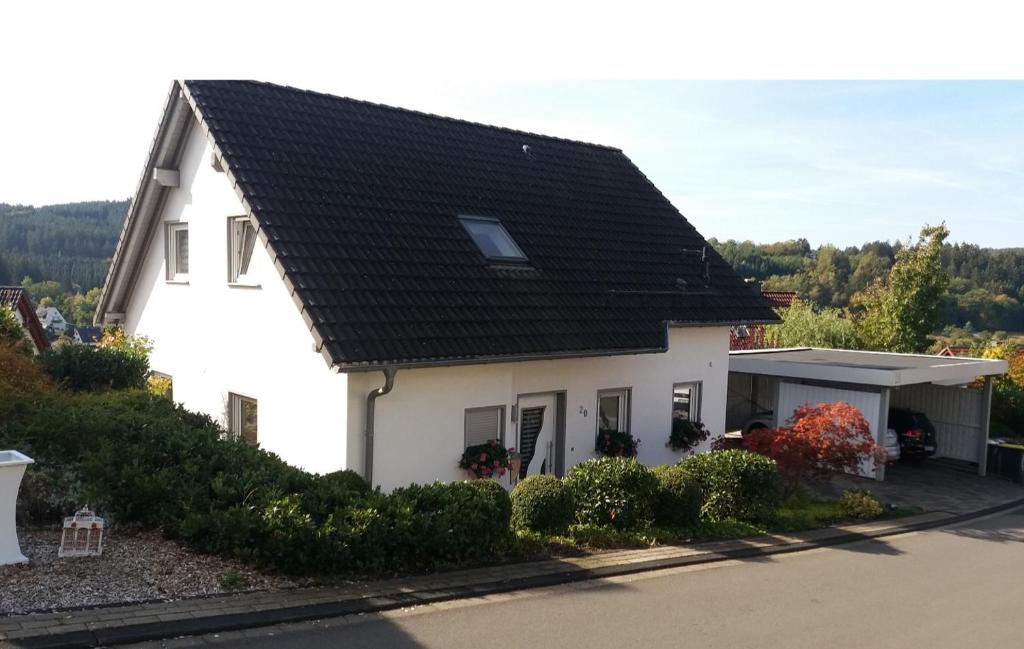 a white house with a black roof at Schmidts 2RAUMTRAUM in Hilchenbach