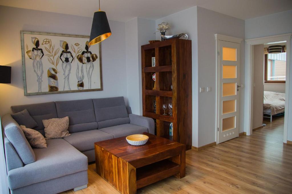a living room with a couch and a coffee table at Apartamenty Świnoujście - Platan in Świnoujście