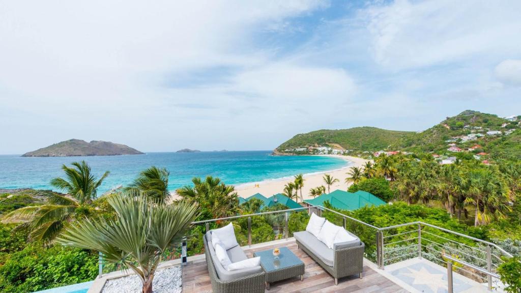 a view of the beach from the balcony of a resort at Dream Villa Flamands 743 in Saint Barthelemy