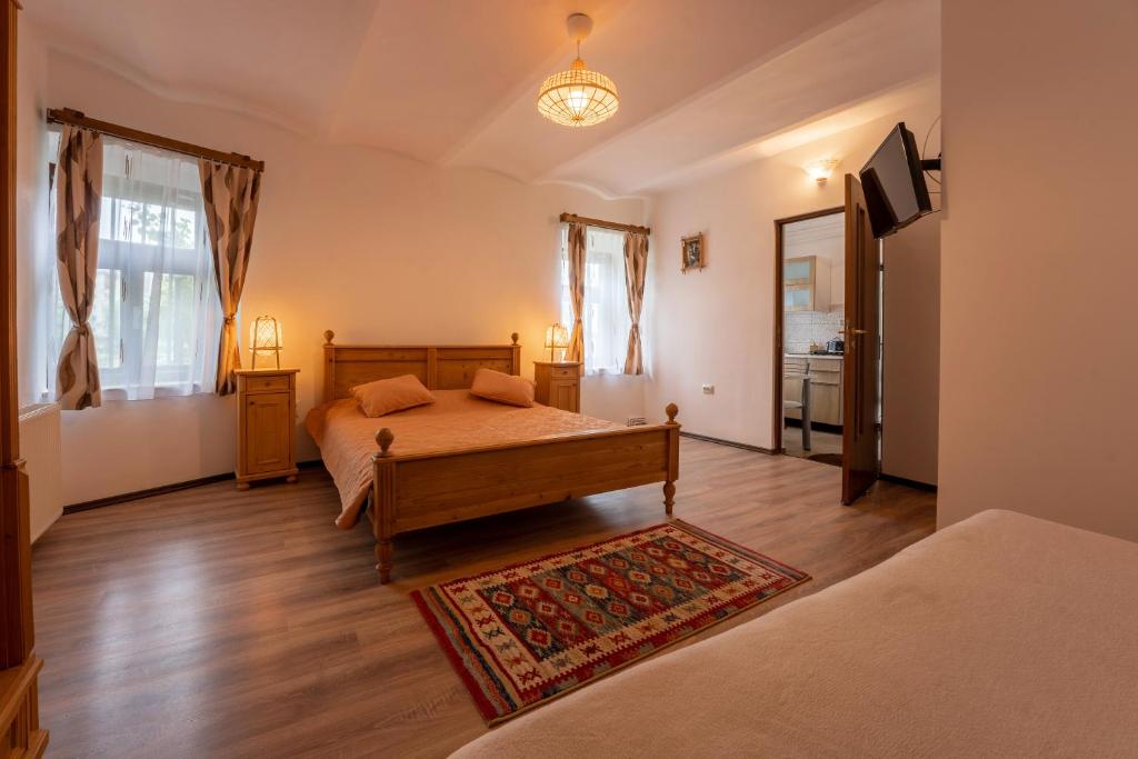 a bedroom with a bed and a rug at Gloria Apartments in Sighişoara