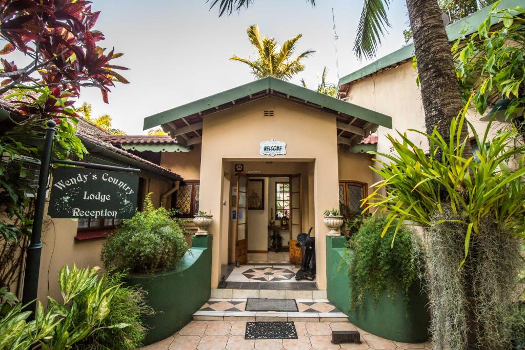 a building with a sign in front of it at Wendy's Country Lodge in Mtubatuba