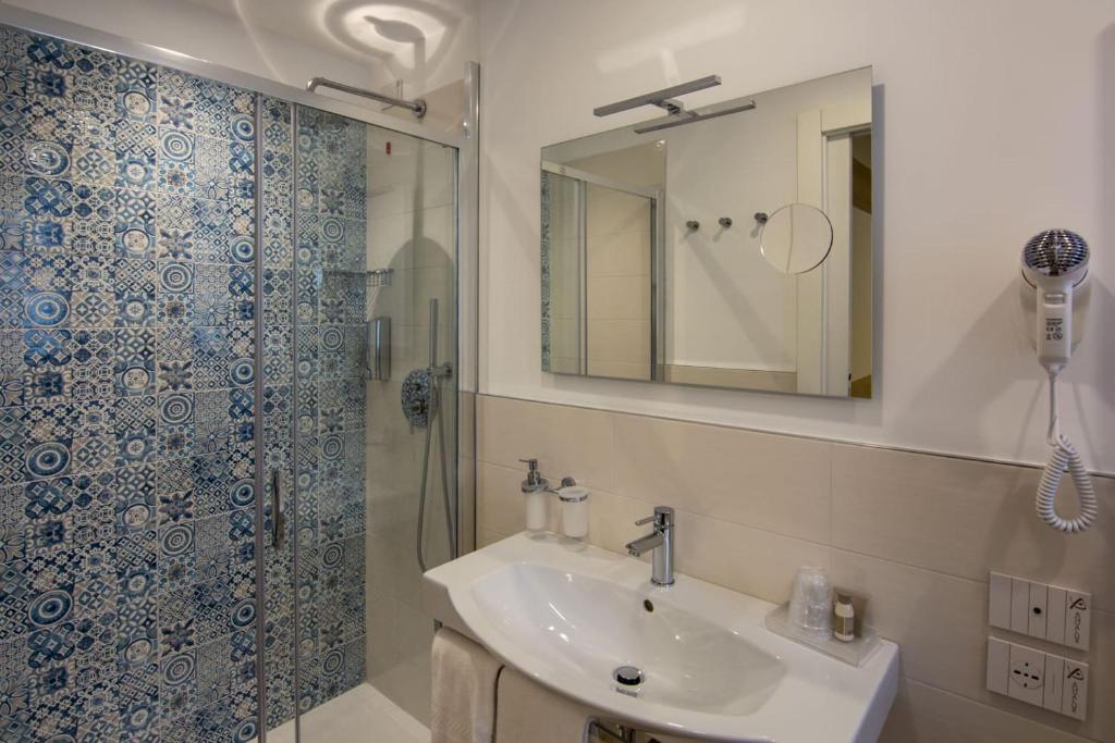 a bathroom with a sink and a shower at Almalux Jesolo Wellness & Spa 3 stelle superior in Lido di Jesolo