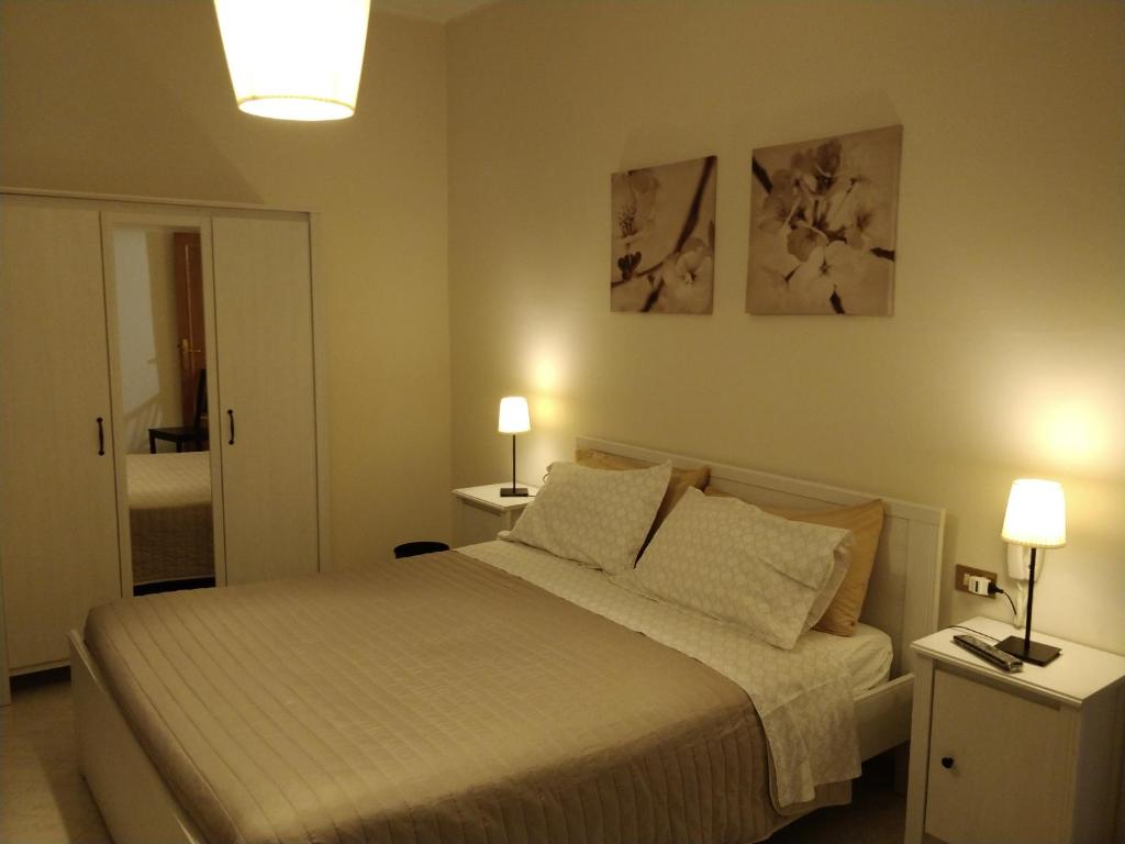een slaapkamer met een bed en twee lampen op tafels bij Isi GuestHouse in Iesi