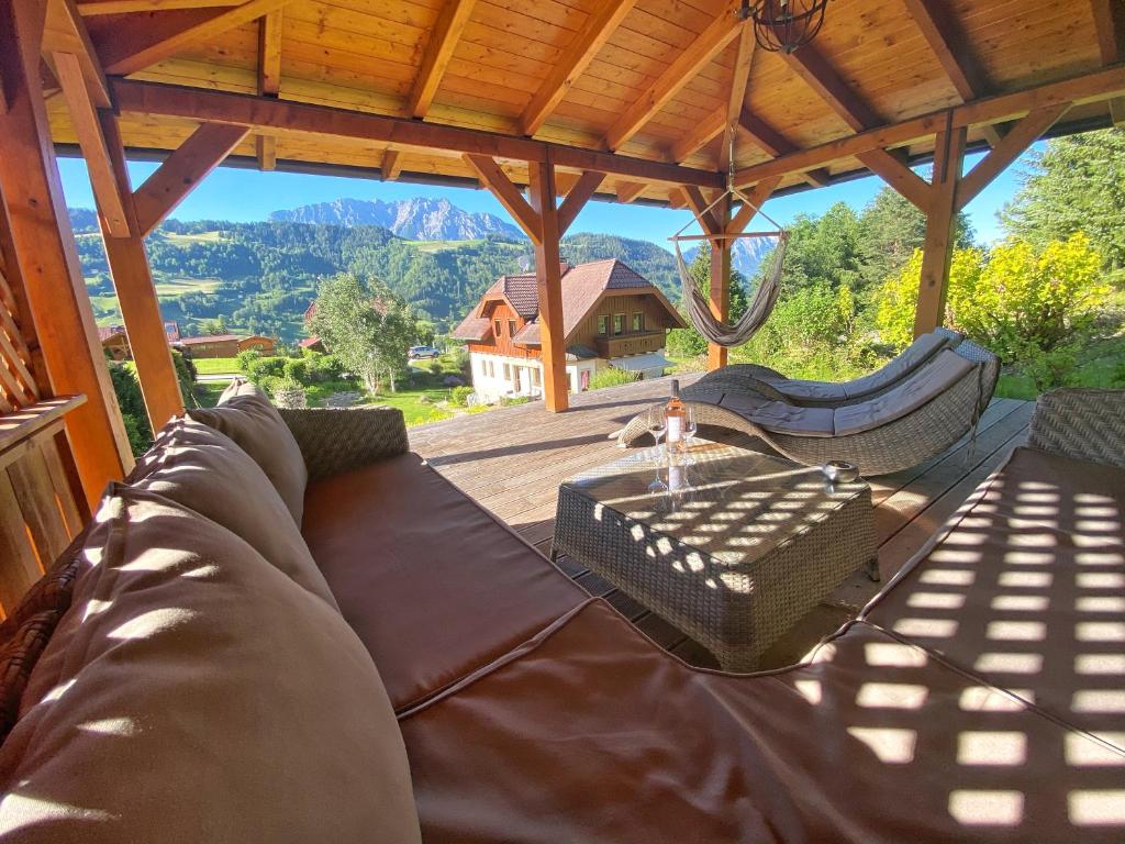 a couch on a porch with a view of a mountain at Ferienhaus Schaller am Galsterberg in Pruggern