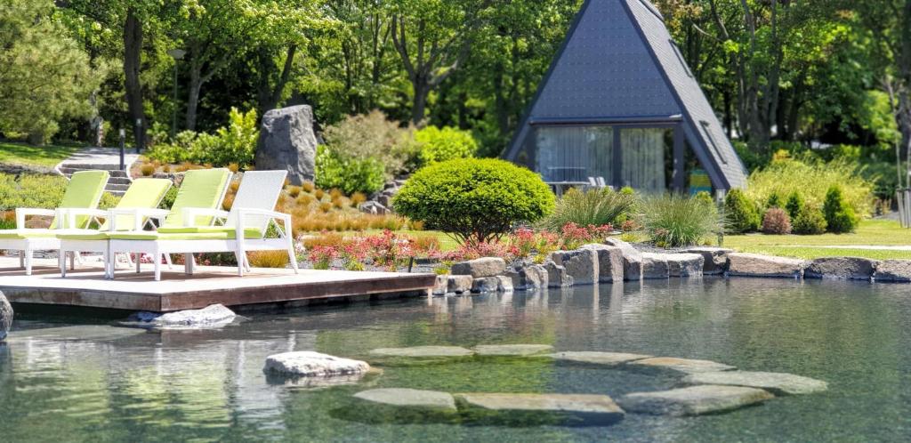 un grupo de sillas sentadas en un muelle sobre un estanque en Zen Garden Resort, Zánka en Zánka