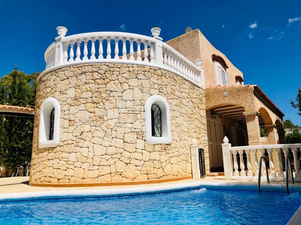 a house with a swimming pool in front of it at Villa Casa Diego Ibiza in Santa Eularia des Riu