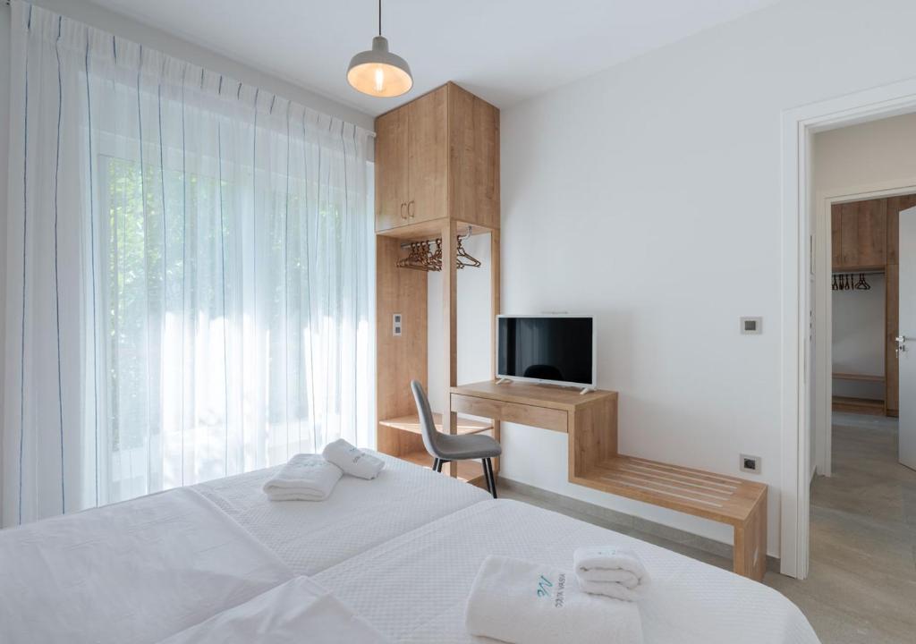 Katil atau katil-katil dalam bilik di COSTA VASIA Seaside Suites and Apartments