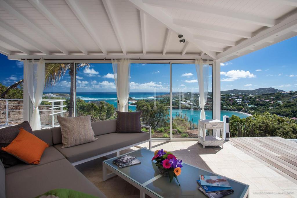 a living room with a couch and a view of the ocean at Dream Villa Mont Jean 661 in Saint Barthelemy