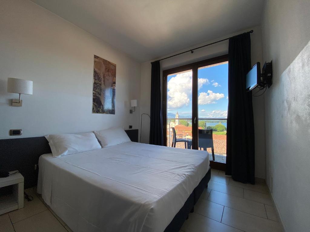 Postel nebo postele na pokoji v ubytování Hotel La Locanda