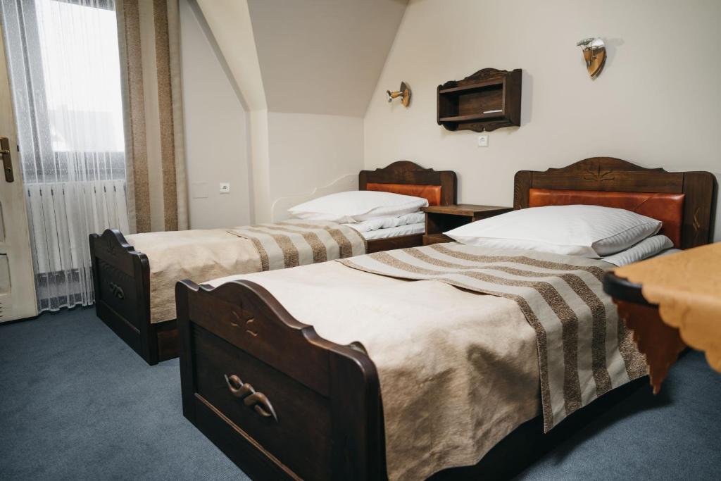 Posteľ alebo postele v izbe v ubytovaní Hawrań Bukowina