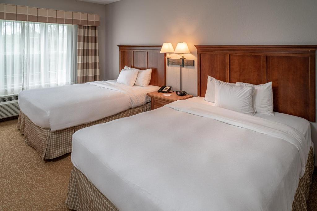 a hotel room with two beds and a window at Country Inn & Suites by Radisson, Beckley, WV in Beckley