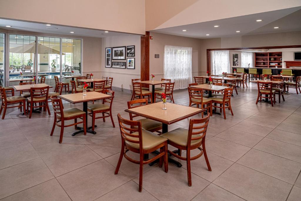 a dining room with wooden tables and chairs at Country Inn & Suites by Radisson, Beckley, WV in Beckley