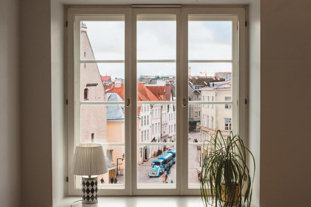 an open window with a view of a city at Tallinn City Apartments Old Town Square in Tallinn