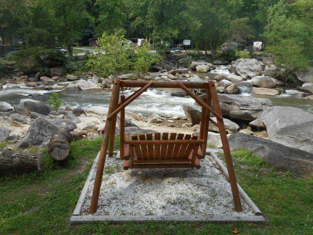 une balançoire assise en face d'une rivière dans l'établissement The Evening Shade River Lodge and Cabins, à Chimney Rock