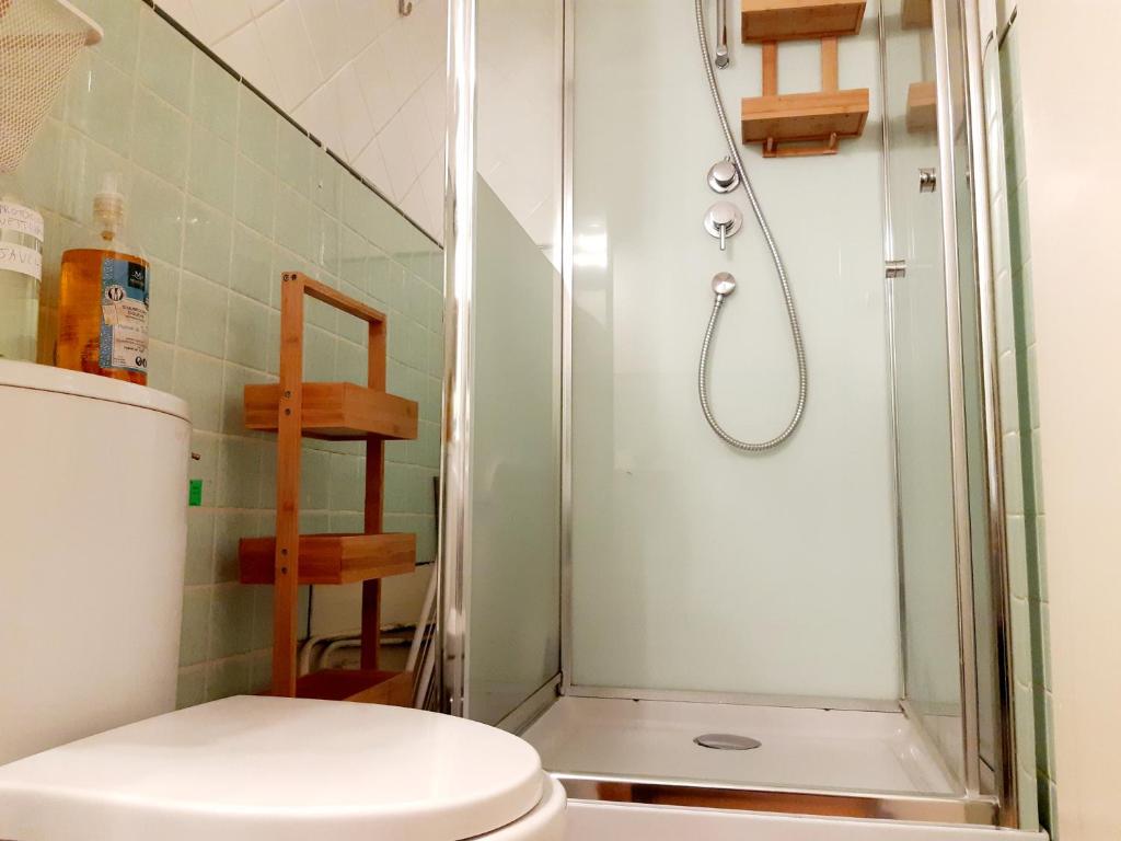 a bathroom with a shower and a toilet at La Villa des Thermes in Le Mont-Dore