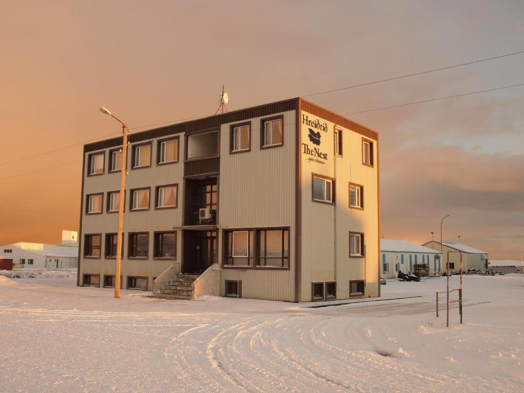 a building in the middle of a snowy field at The Nest in Raufarhöfn