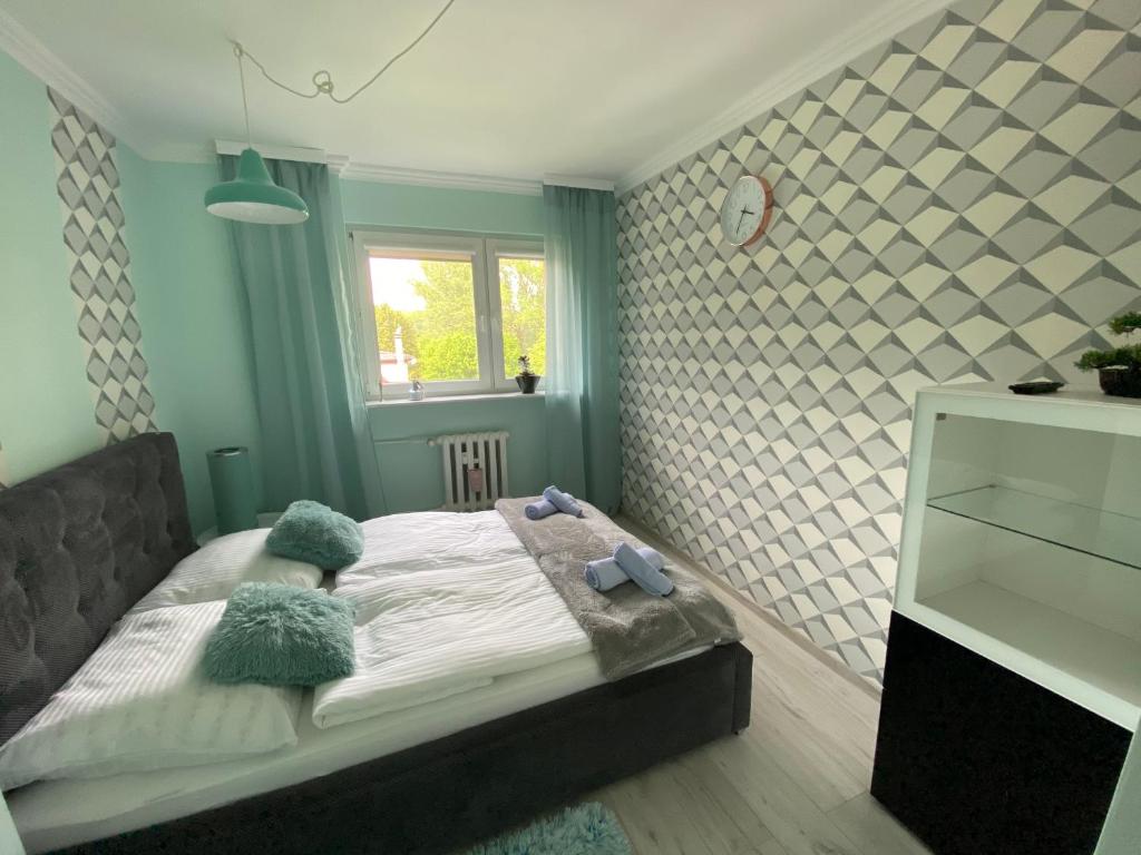 Posteľ alebo postele v izbe v ubytovaní Blue Sky Apartament