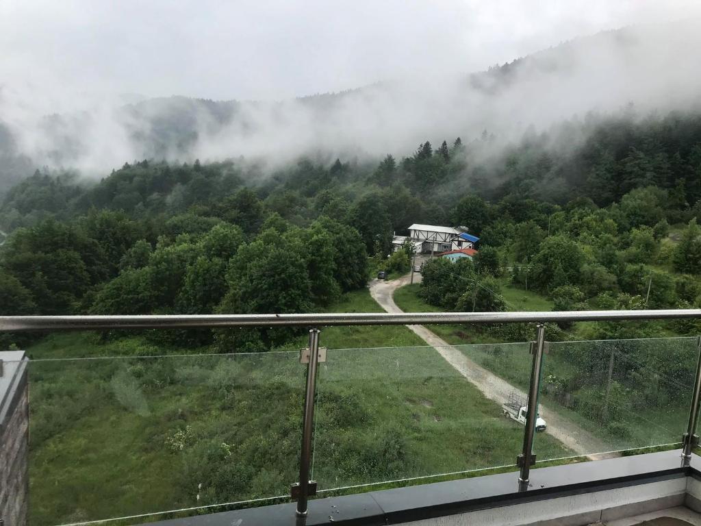 a view of a misty mountain with a train on a road at MOUNTAIN RESIDENCE in Sinaia