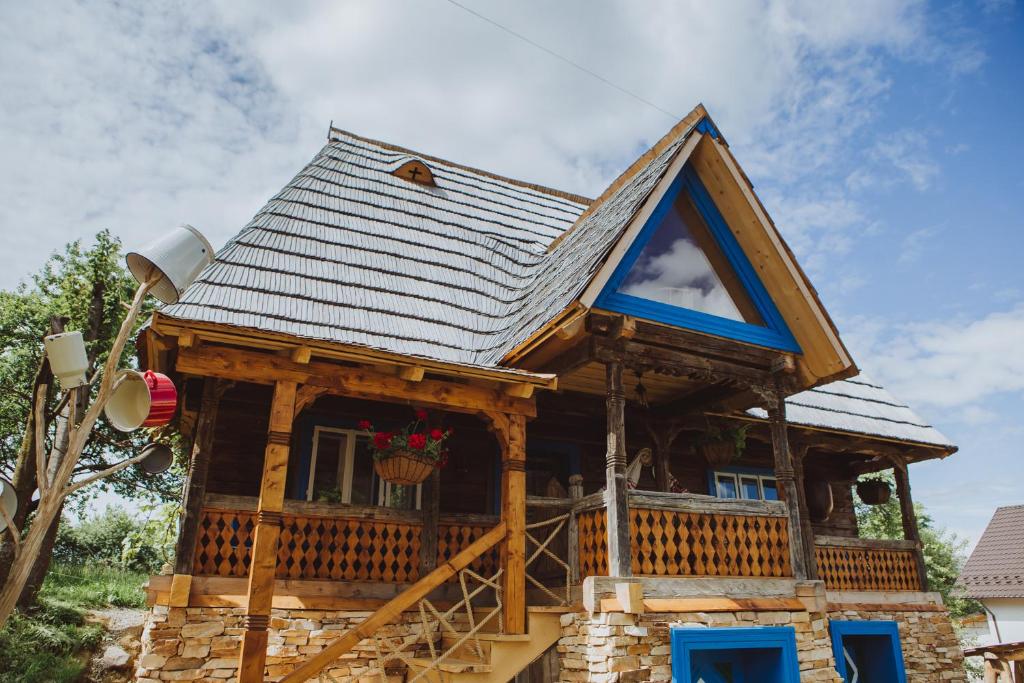 une maison avec un toit en gambrel dans l'établissement Casa Moroșenilor - Breb, à Breb