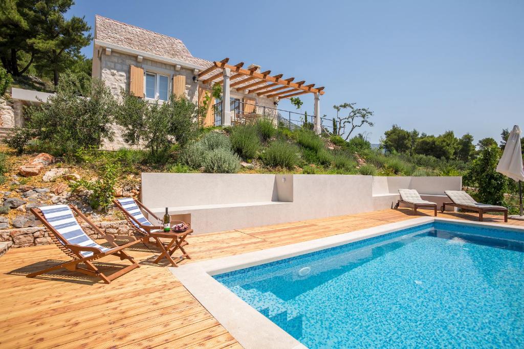 a villa with a swimming pool and a house at Villa Brac with pool Bol in Bol