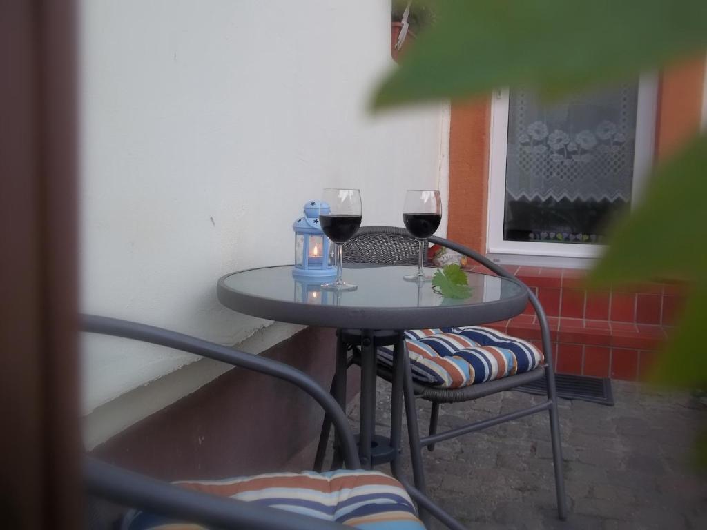 a table with two glasses of red wine on it at Fewo Pfalzwohnung in Ellerstadt