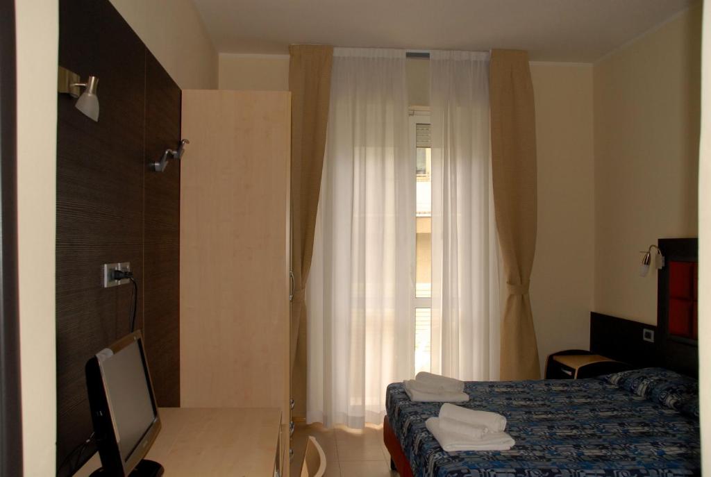 Postel nebo postele na pokoji v ubytování Hotel Arno