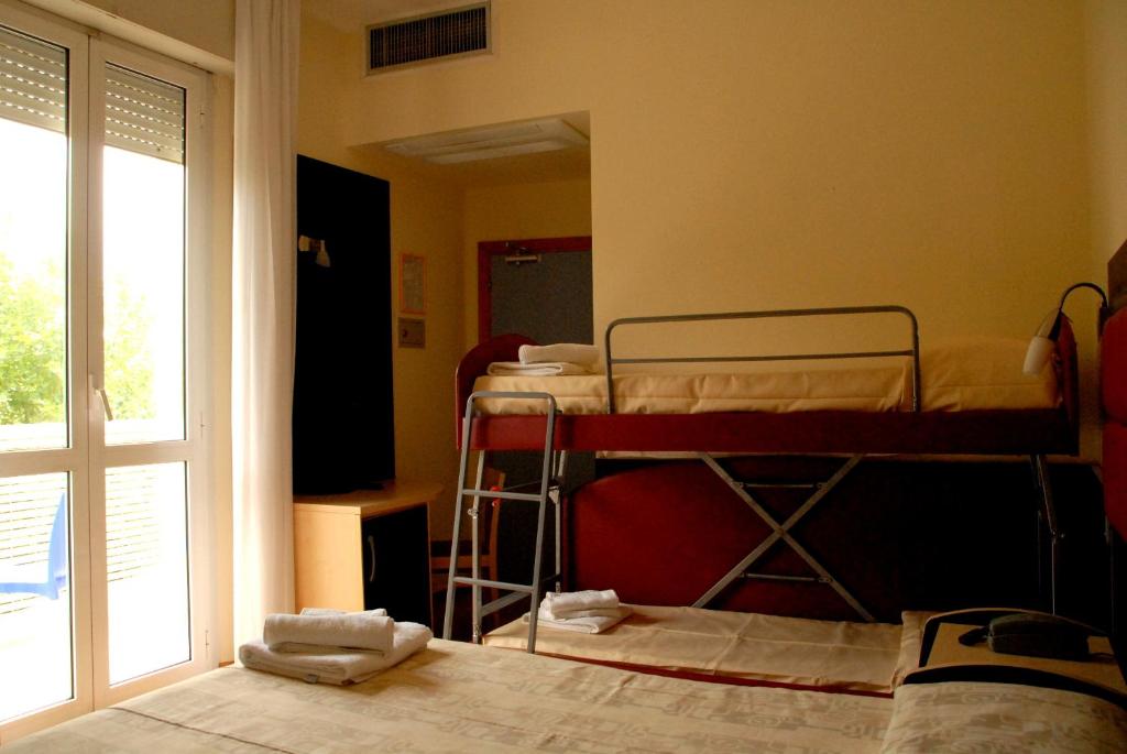 Postel nebo postele na pokoji v ubytování Hotel Arno
