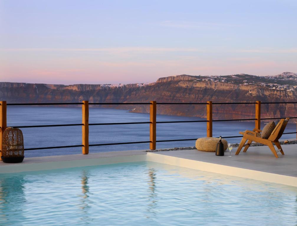 a swimming pool with a view of the mountains at Melidonia Suites in Akrotiri