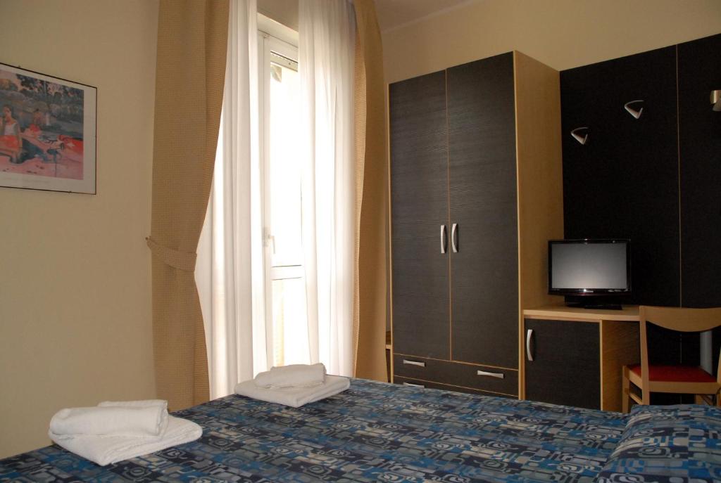 Postel nebo postele na pokoji v ubytování Hotel Arno