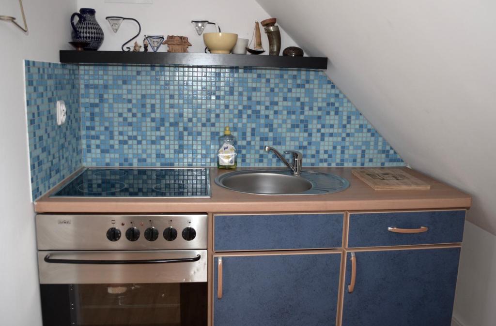 a small kitchen with a sink and a stove at Apartamenty u Majki in Frydman