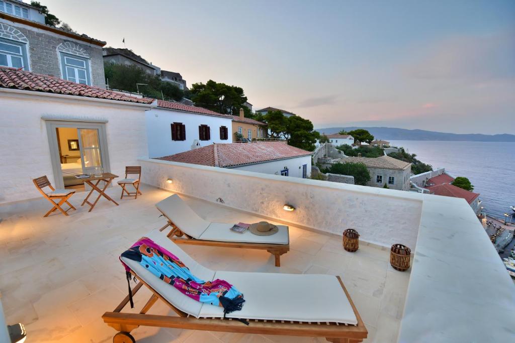 a balcony of a house with a view of the ocean at Onar Hydra in Hydra