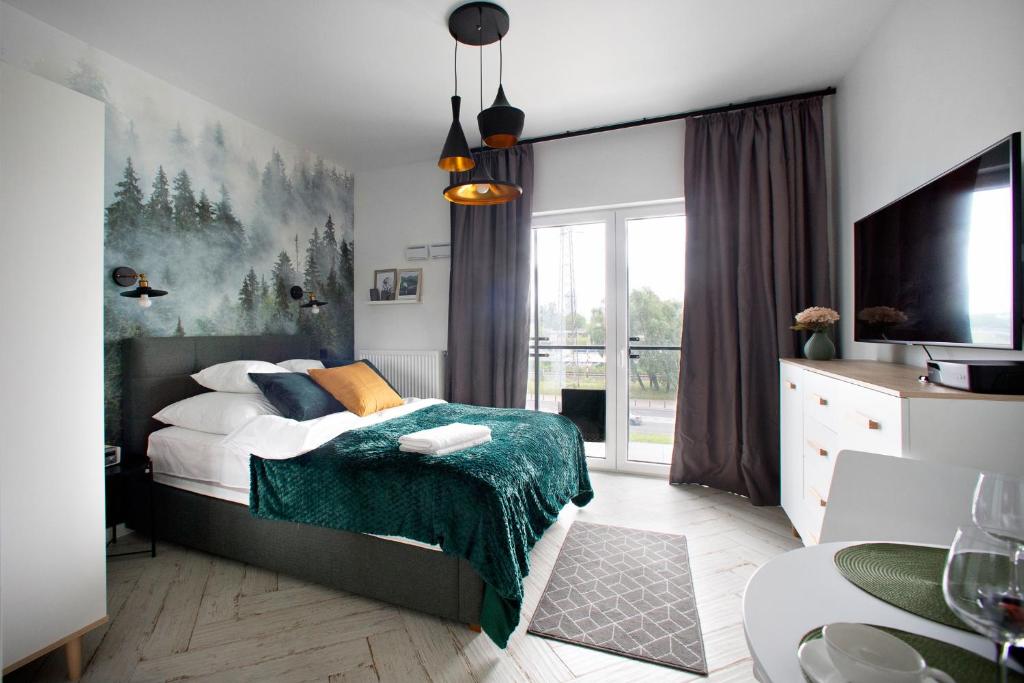 מיטה או מיטות בחדר ב-Prymasa Tysiaclecia - P&O Serviced Apartments