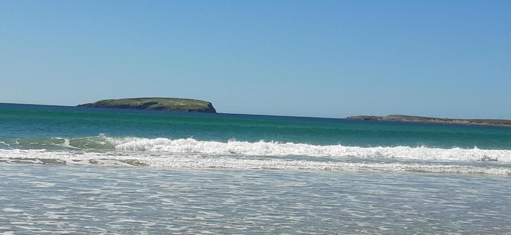 a group of waves in the ocean on a beach at Creevagh (Room Only) in Keel