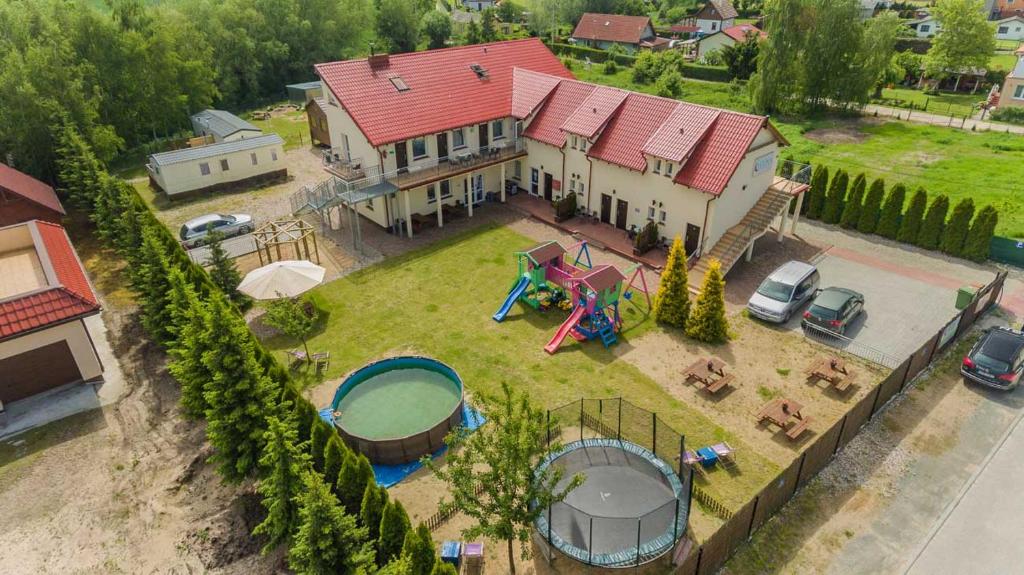 an aerial view of a house with a playground at Dom Goscinny Luna in Stegna