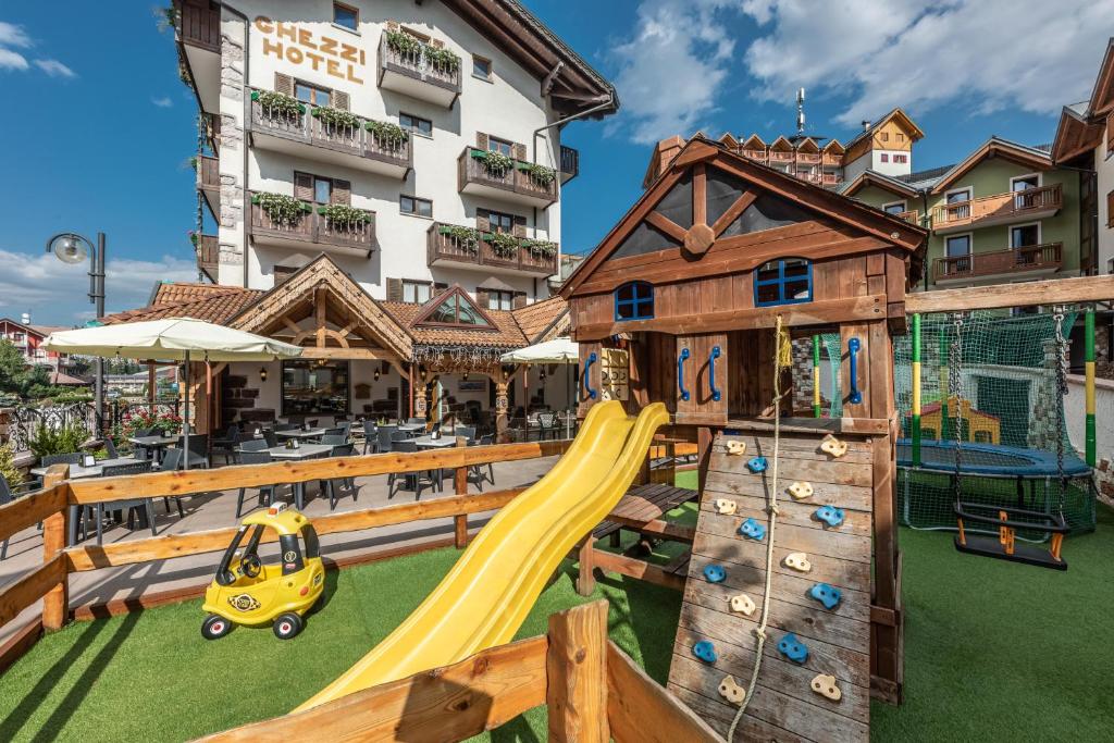 a playground at a hotel with a slide at Hotel Ghezzi in Andalo