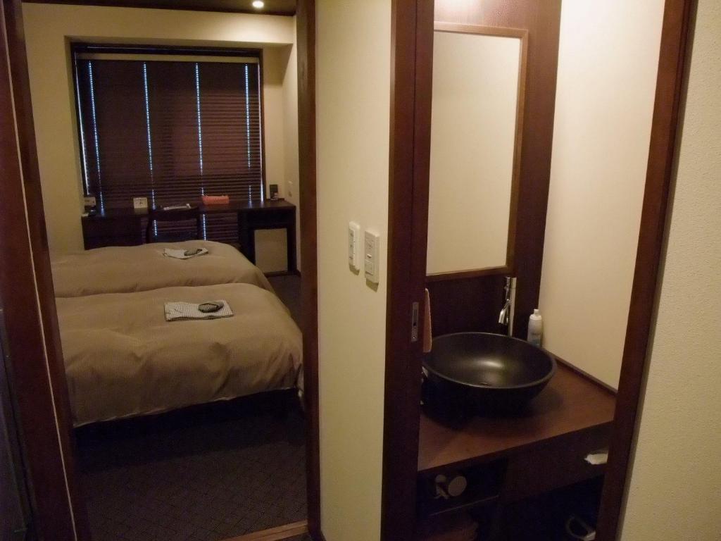 Postel nebo postele na pokoji v ubytování Ochanomizu Hotel Shoryukan
