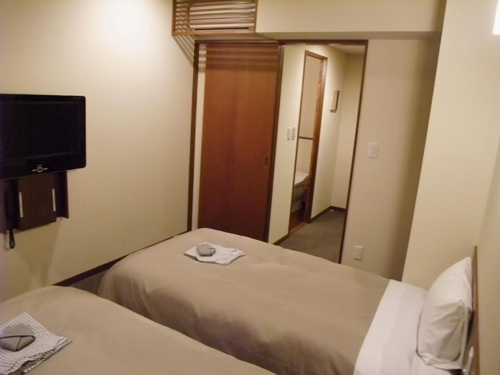 Postel nebo postele na pokoji v ubytování Ochanomizu Hotel Shoryukan