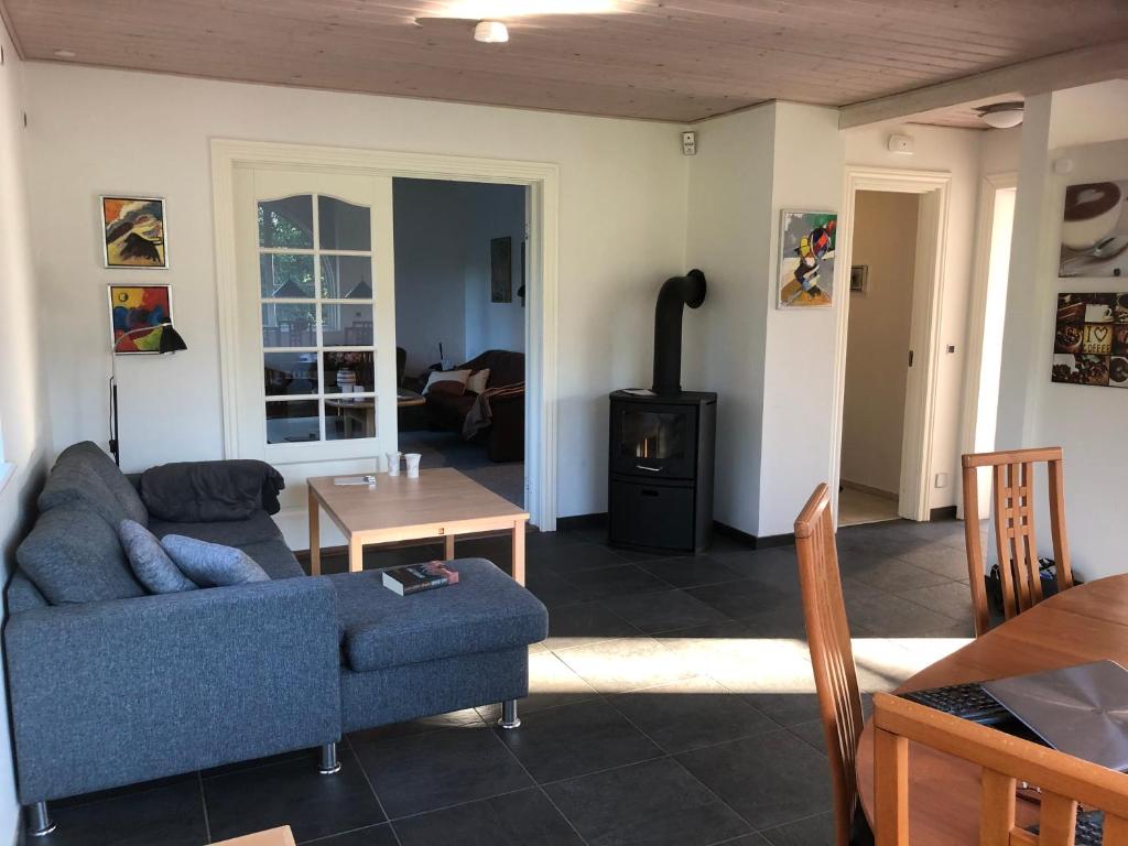 a living room with a couch and a stove at SLEEPIND in Aabenraa