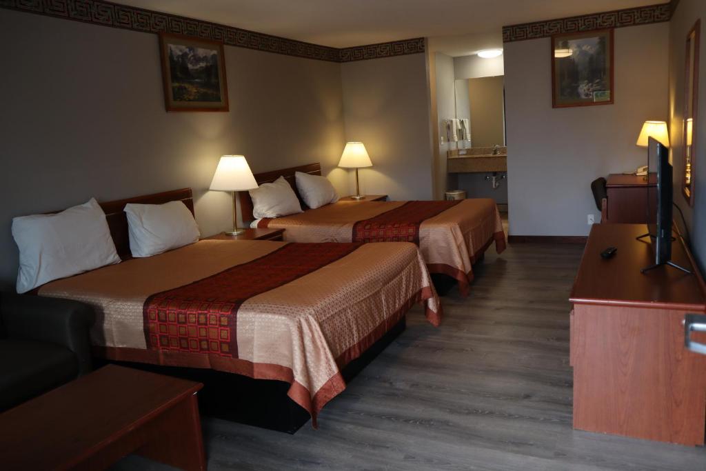 Postel nebo postele na pokoji v ubytování Executive Motel