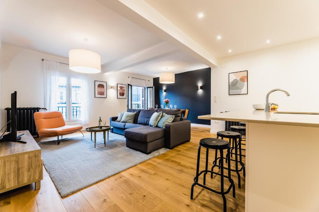 a kitchen and living room with a couch and a table at ZABALETA by SWEET HOME SAN SEBASTIAN in Donostia-San Sebastián