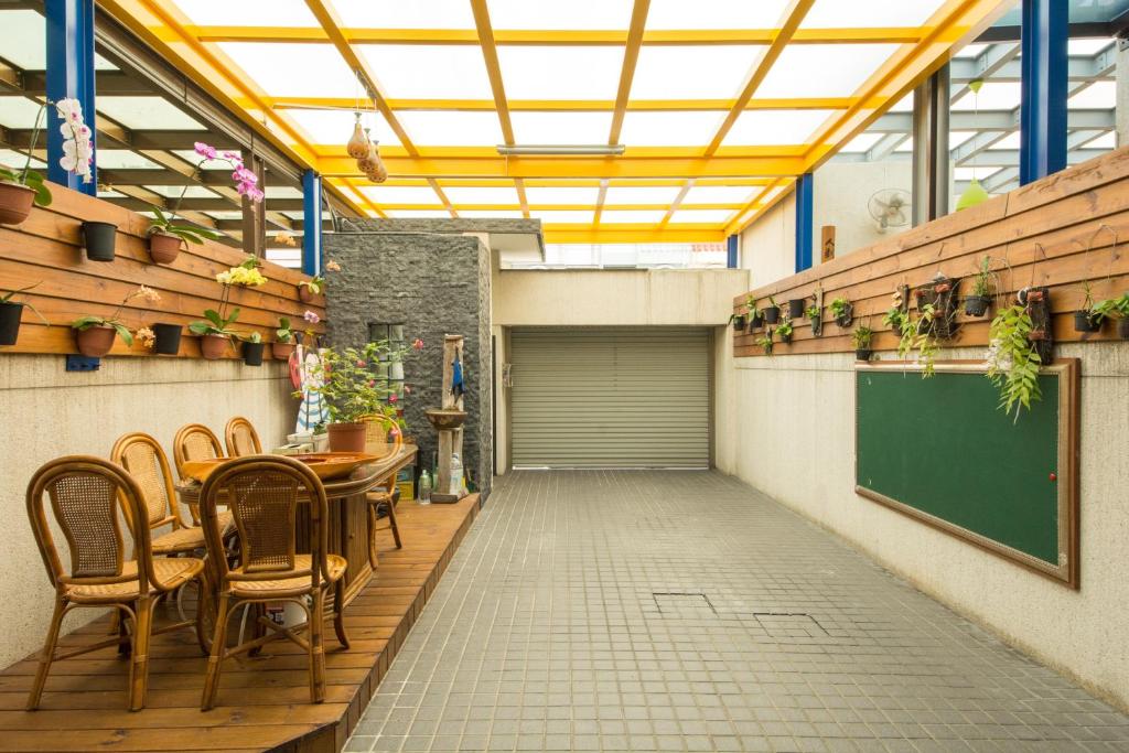 a restaurant with a table and chairs and a chalkboard at Sunflower B&amp;B II in Hualien City