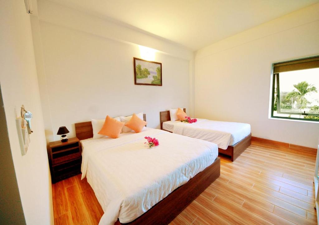 Giường trong phòng chung tại Lavila Homestay Hoi An