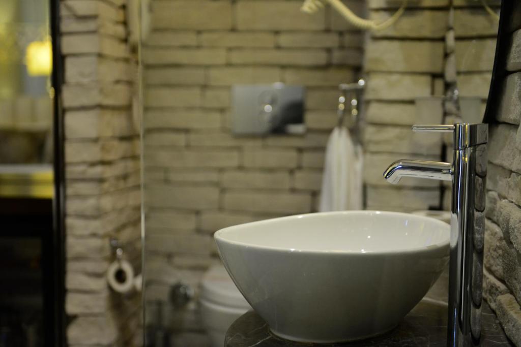 a bathroom with a white bowl sink on a counter at Taksim Pera Center Hotel in Istanbul