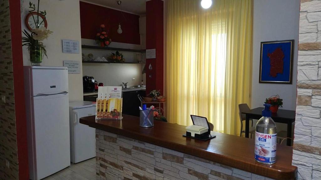 a kitchen with a counter top and a refrigerator at Coral Rubrum in Alghero
