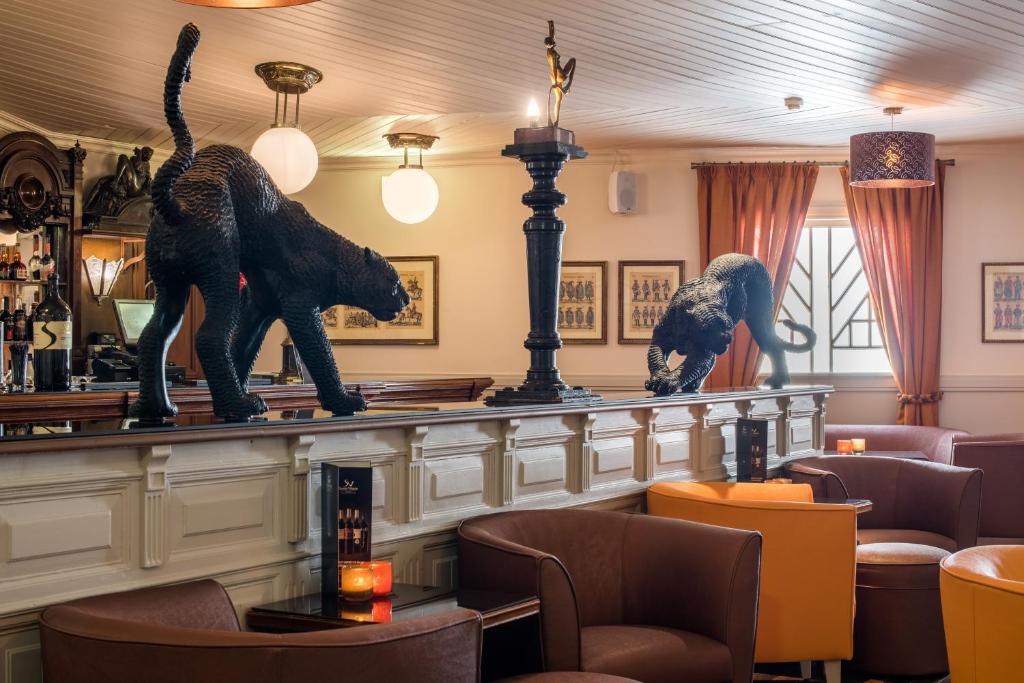 two statues of animals on a counter in a restaurant at Vila Galé Estoril in Estoril