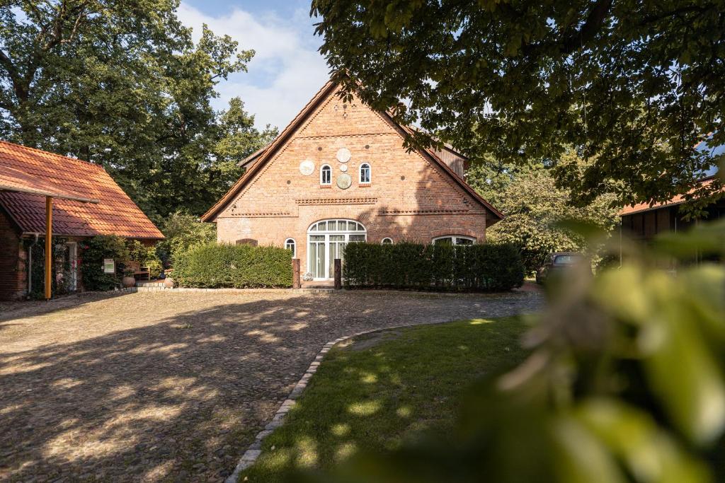 a large brick building with a large window at Ramakers Hof in Kirchlinteln